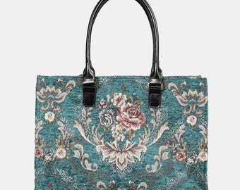 May include: A teal blue tote bag with a floral tapestry design. The bag has black leather handles and a top zipper closure.