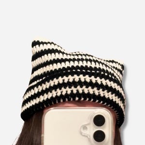 May include: Black and white striped crocheted beanie hat.