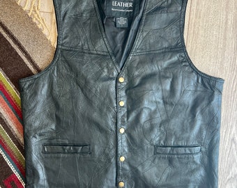 May include: Black leather vest with a quilted design and a label that reads "Genuine Leather, Western Leather Company".