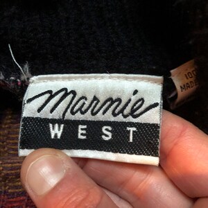 May include: White label with black text that reads "Marmie West".