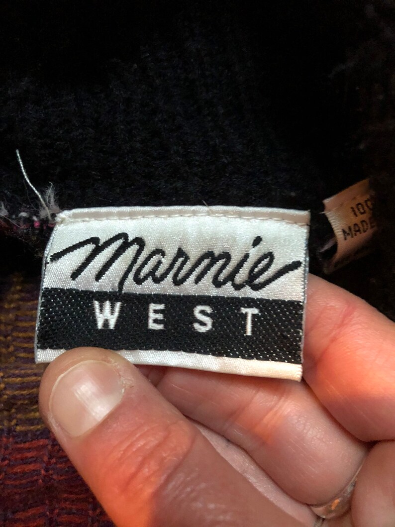 May include: White label with black text that reads "Marmie West".