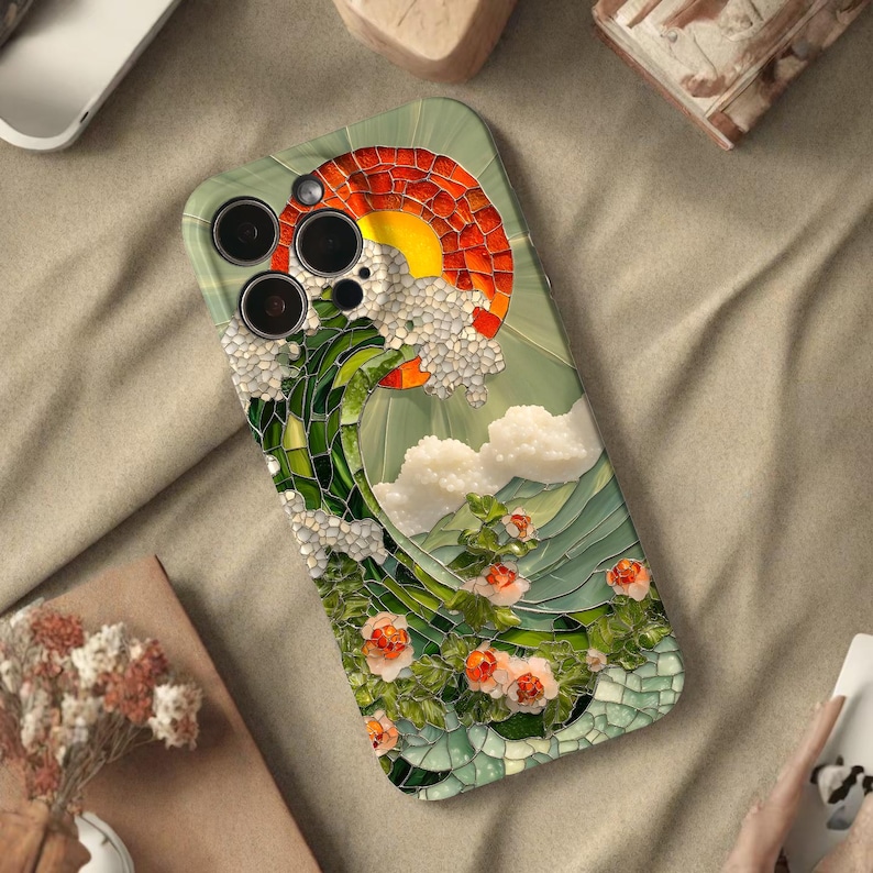 Może przedstawiać: Etui na telefon z mozaikowym wzorem zachodu słońca nad falą, z białymi chmurami i pomarańczowymi kwiatami. Etui ma zielono-białą kolorystykę.