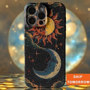 May include: A black phone case featuring a celestial design with a sun, moon, and stars. The sun is yellow and orange, the moon is blue, and the background is a starry night sky. The case has a glossy finish.