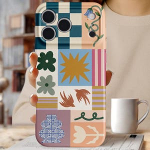 May include: A colorful phone case with a patchwork design. The case features a variety of geometric and floral patterns in shades of blue, green, orange, pink, and white. The design includes a checkered pattern, flowers, birds, and a sunburst.