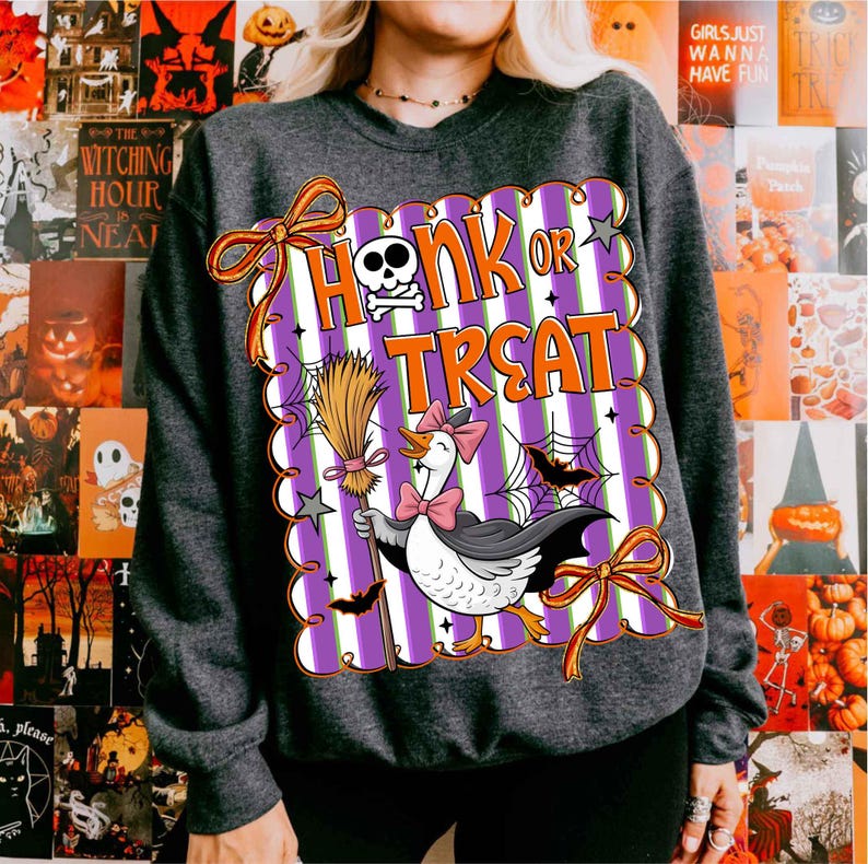 May include: Dark gray sweatshirt with a Halloween-themed graphic. The graphic features a goose wearing a bow tie and cape, holding a broom, with the words "Honk or Treat". The design includes bats, spiderwebs, and a skull.