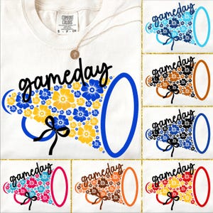 May include: Cream-colored t-shirt with the word "gameday" in black script. A megaphone design is filled with blue and yellow flowers. Additional megaphone designs in various colors are also shown.