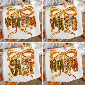 Op de afbeelding: Vier witte sweatshirts worden getoond, elk met een andere naam in een herfstthema-ontwerp. De namen, "Mama", "Mimi", "Gigi" en "Nana", zijn in dierenprint en herfstkleuren, met een strik en bladeren.