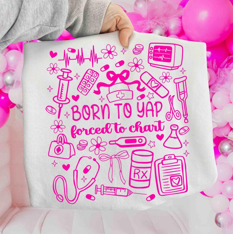 May include: White throw blanket featuring a pink medical design. The design includes a stethoscope, pills, a syringe, a heart monitor, and the text "BORN TO YAP forced to chart."