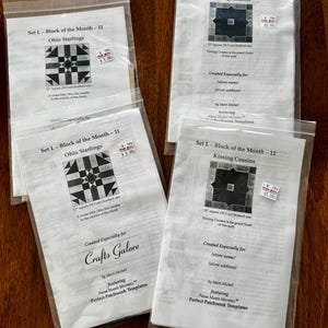 May include: Four clear plastic bags containing quilt block patterns by Marti Michell. Two bags are labeled Set L - Block of the Month - 11 Ohio Starlings, and two are labeled Set L - Block of the Month - 12 Kissing Cousins, each noting 12 inch finished size.