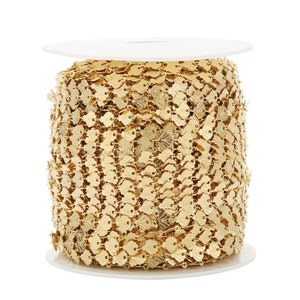 May include: A spool of gold-colored chain with a heart-shaped link design.