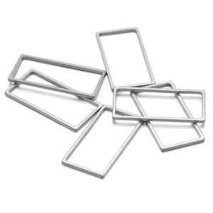 May include: Five silver metal rectangular rings, stacked and overlapping, on a white background.