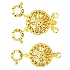 May include: Two gold-toned metal clasps with a decorative, circular design. Each clasp has a round, open loop on either side and a smaller, closed loop on the bottom.