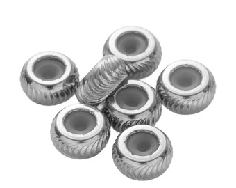 May include: A selection of silver metal beads. The beads are round with a central hole and a textured, ridged surface. These beads are likely used for jewellery making or crafting projects.