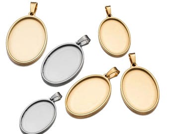 May include: Five oval-shaped pendant trays with a silver and gold finish. The trays have a smooth, shiny surface and are ready to be filled with resin or other materials.
