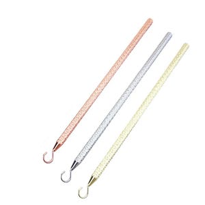 May include: Three metal crochet hooks with a textured finish. The hooks are in rose gold, silver, and gold.