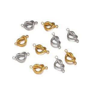 May include: A collection of gold and silver heart-shaped knot connectors with two jump rings. These connectors are ideal for jewellery making and crafting.
