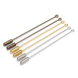 May include: Five straight metal pins with rounded ends. The pins are in different colours: bronze, gold, and silver.