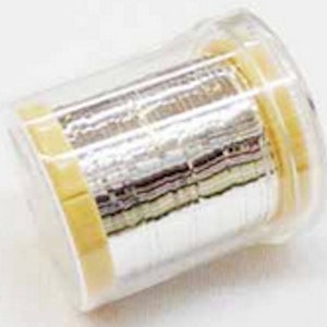May include: A spool of silver wire wrapped in clear plastic and a yellow label. The wire is wound tightly and appears to be very fine.