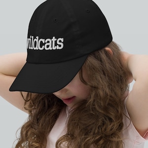 May include: A black baseball cap with white embroidered text that reads "Wildcats".