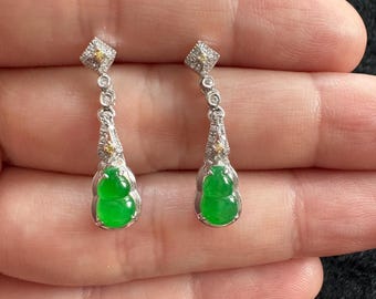 May include: A pair of jade earrings with a gourd shape, set in white gold with diamond accents.