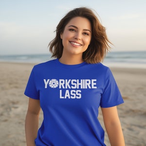 May include: A royal blue t-shirt with a white graphic that says "YORKSHIRE LASS" with a white snowflake design.