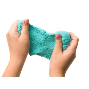 May include: A pair of hands holding and squeezing a bright turquoise slime. The slime is soft and textured, and the hands are gently pressing it together.