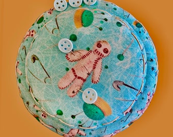 Pincushion. Voodoo Doll Theme. Whimsical Fun. Designer Fabric. Aqua Hues. Unique Disk Shape. Completely Handsewn.  Free Ship U.S. Only.