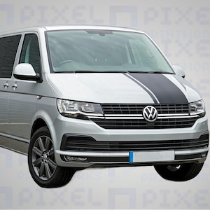 May include: Silver minivan with a black racing stripe down the hood. The vehicle has dark gray wheels and a Volkswagen emblem on the front grille. The headlights are on, and the vehicle is parked.