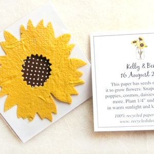May include: A yellow paper sunflower with a brown and white polka dot center. The paper has embedded seeds to grow flowers like snapdragons, poppies, cosmos, daisies, and marigolds. The paper is 100% recycled and made by Recycledideasfavors.com. The text on the paper reads "Kelly & Ben 16 August 2015".