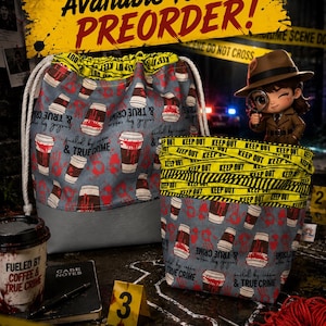 May include: A drawstring bag and a fabric basket featuring a pattern of coffee cups with red blood-like splatters and the text "fueled by coffee & TRUE CRIME". The items have yellow "KEEP OUT" tape trim and white drawstring cords.