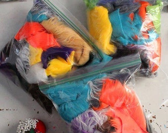 May include: Three clear plastic bags filled with colorful craft fur. The fur is in various colors, including blue, yellow, orange, and purple.