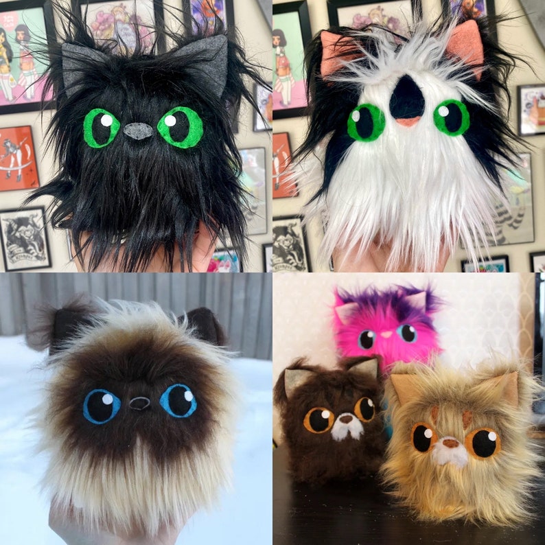 May include: Five plush cat toys. The first is black with green eyes, the second is white with black markings and green eyes, the third is brown and white with blue eyes, the fourth is brown with orange eyes, and the fifth is pink with purple fur and pink eyes.