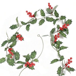 May include: A long garland of artificial holly leaves and red berries. The garland is made of plastic and is ideal for decorating for the festive season.