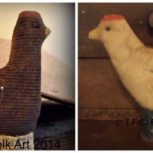 May include: Two handmade fabric chickens, one brown and one white, with red accents on their heads. Both chickens have a pin stuck in their back, suggesting they are pincushions. The brown chicken is sitting on a wooden surface, while the white chicken is hanging from a wooden surface. The image includes the text "© T.F.C. Folk Art 2014".