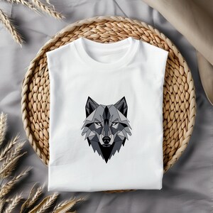 May include: White t-shirt with a geometric wolf design in shades of gray.