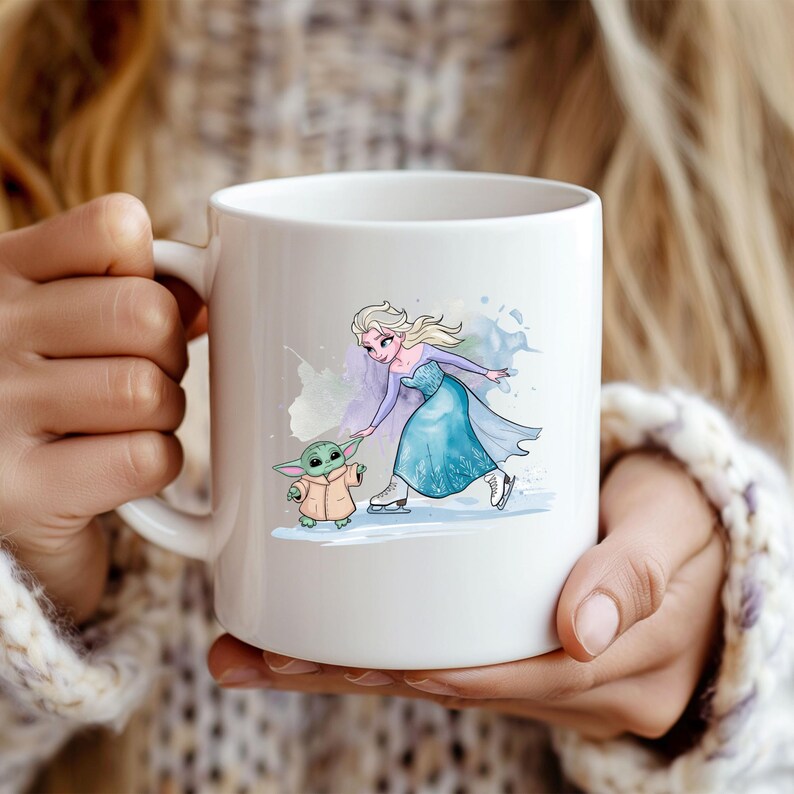 May include: White ceramic mug with a watercolor illustration of Elsa from Frozen ice skating with a small green character. The illustration is on a white background.