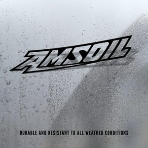 May include: Black AMSOIL logo on a silver background with water droplets. The text "DURABLE AND RESISTANT TO ALL WEATHER CONDITIONS" is at the bottom of the image. The logo is a stylized, angled design.