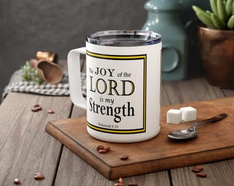 May include: White ceramic mug with a black border and yellow text that reads "The JOY of the LORD is my Strength, Nehemiah 8:10".