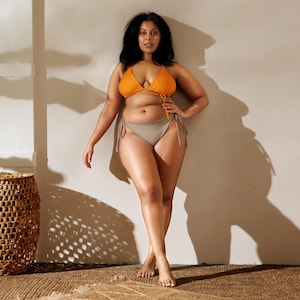 May include: A white ceramic mug with a black handle and the text "But first, coffee" in a handwritten style. The mug is on a white surface. The mug is likely for hot beverages.