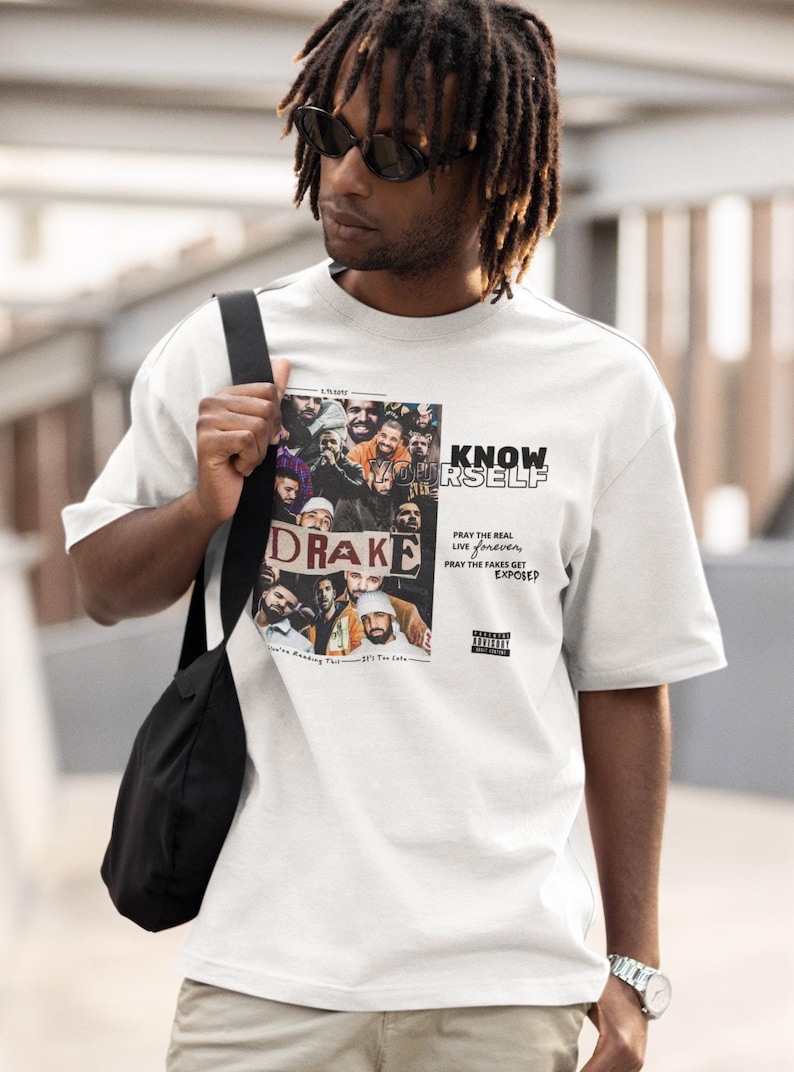 May include: White t-shirt with a collage of images of Drake and the text "KNOW YOURSELF" and "PRAY THE REAL LIVE FOREVER, PRAY THE FAKES GET EXPOSED".
