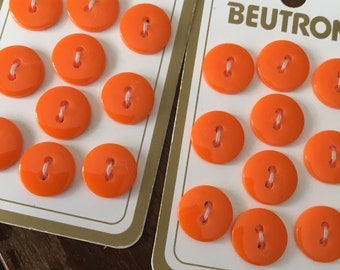 Two cards of Beutron orange round two hole buttons