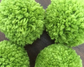 Lot of four large green wool Pom Poms various sizes