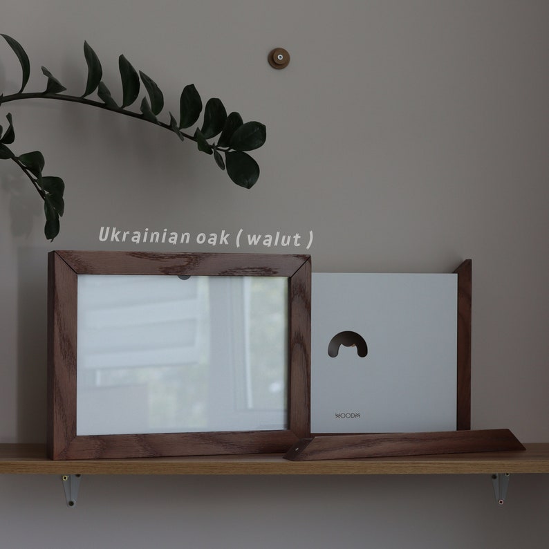 May include: A wooden picture frame with a white mat and a white background. The frame is made of Ukrainian oak (walnut).