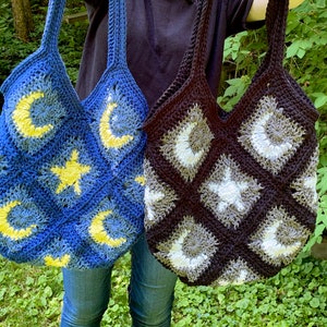 May include: Two crocheted tote bags with a moon and star design. One bag is blue with yellow moons and stars, the other is black with white moons and stars.
