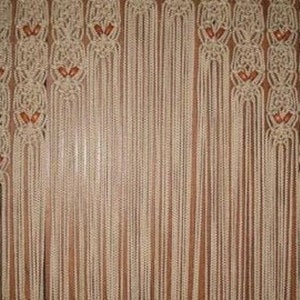 May include: A set of beige macrame curtains with brown beads woven into the design.