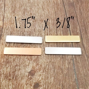 May include: Four metal rectangular blanks in silver, gold, copper, and white. The blanks are 1.75 inches by 3/8 inches.