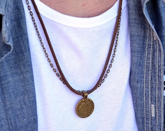 Men's boho charm necklace on leather cord and thin chain, aged, with a round ethnic pendant