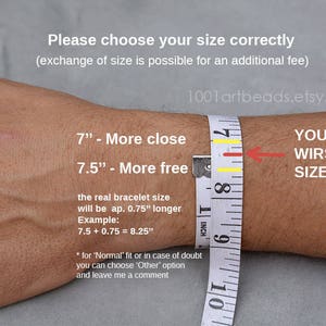 May include: A close-up of a person's wrist being measured with a tape measure. The text on the image reads "Please choose your size correctly (exchange of size is possible for an additional fee)" and "7" - More close 7.5" - More free" and "YOUR WIRST SIZE". The text also includes instructions for measuring the wrist and calculating the bracelet size.