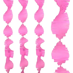 May include: Pink paper streamers in a spiral design. The streamers are made of a soft, textured paper and are arranged vertically against a white background. These decorations are suitable for parties and events.