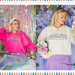 May include: A bright pink long-sleeve sweatshirt with the text OPALITE and dancing through the lightning strikes printed on the front, paired with iridescent sequin trousers, and a cream long-sleeve sweatshirt with the same text and a purple skirt.